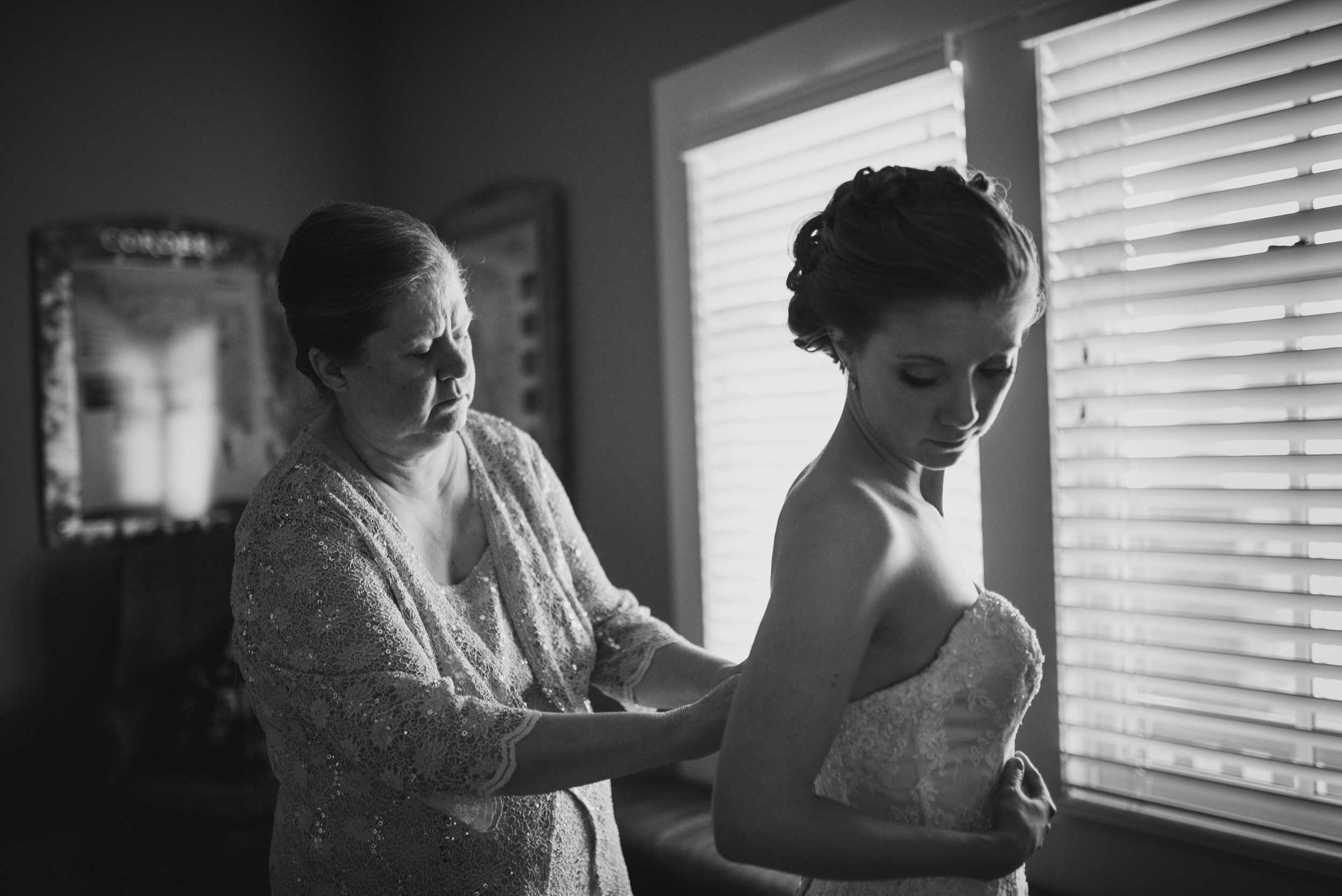 bride getting into gown